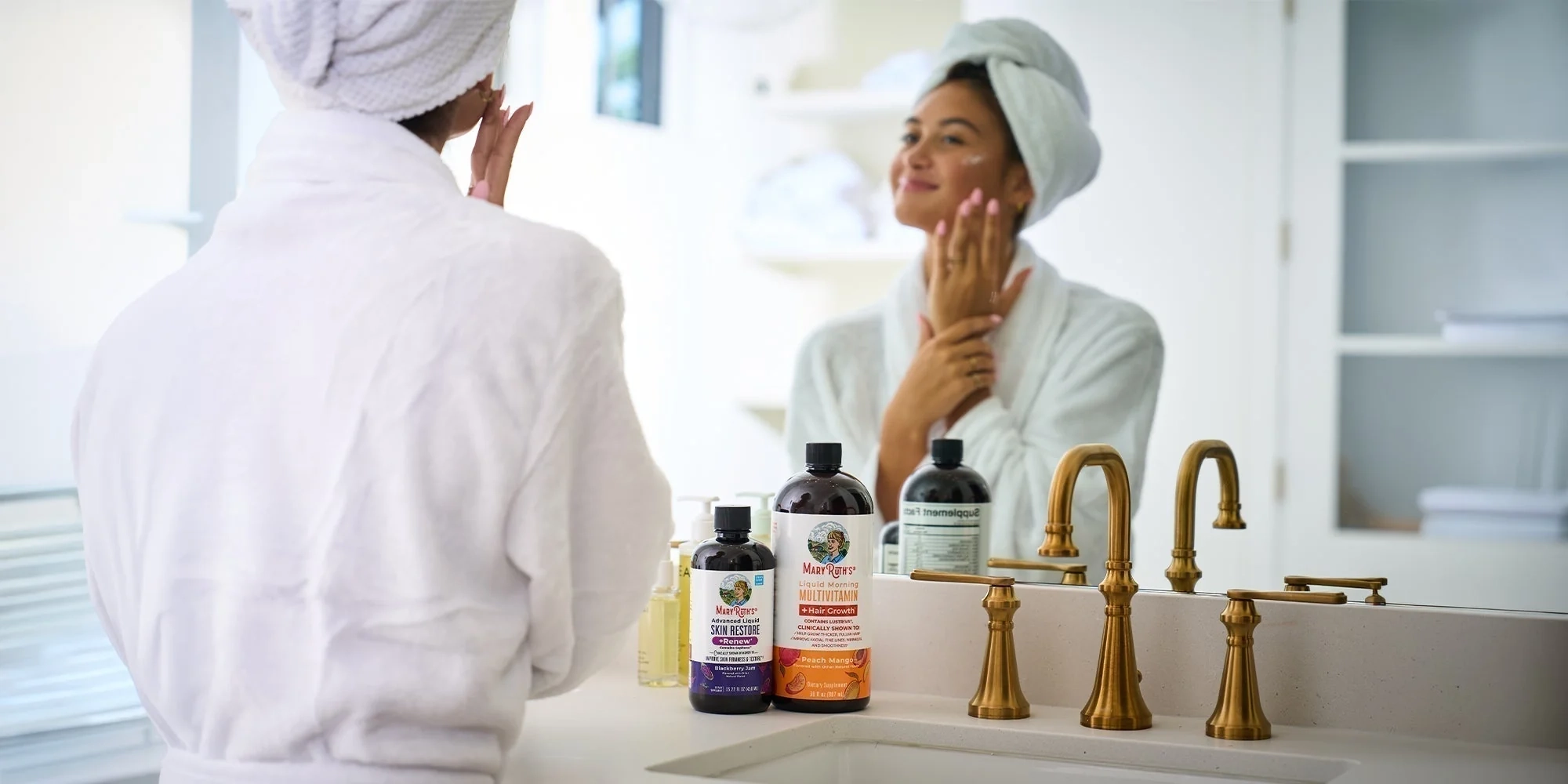 Morning at the bathroom mirror, with Liquid Morning Multivitamin + Hair Growth and Advanced Liquid Skin Restore + Renew on the counter